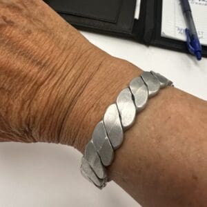 Silver bracelet on a person's wrist.